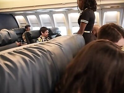 Good sex on a plane of a young couple with a black stewardess